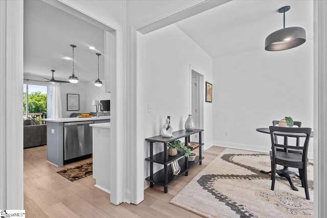 interior space featuring baseboards and light wood finished floors