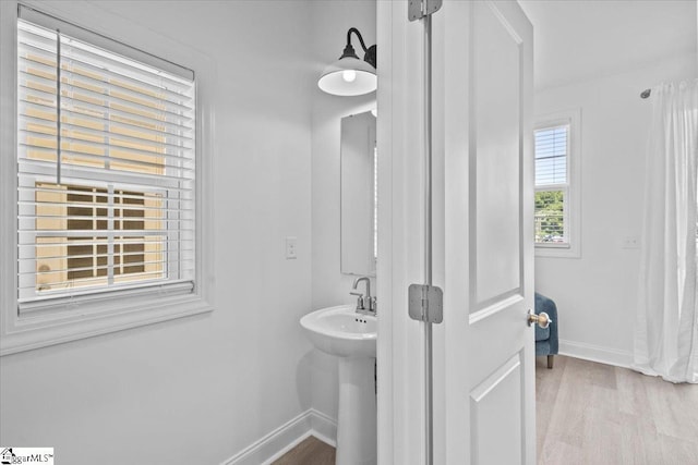 bathroom featuring baseboards and wood finished floors