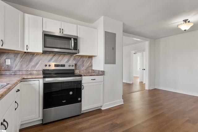 kitchen with stainless steel appliances, dark wood-type flooring, white cabinetry, electric panel, and tasteful backsplash