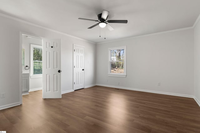 spare room with dark wood-style floors, a ceiling fan, baseboards, and crown molding