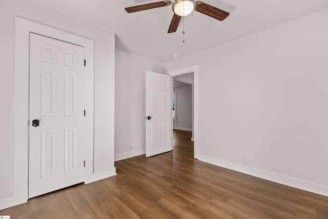 unfurnished bedroom featuring ceiling fan, baseboards, and wood finished floors