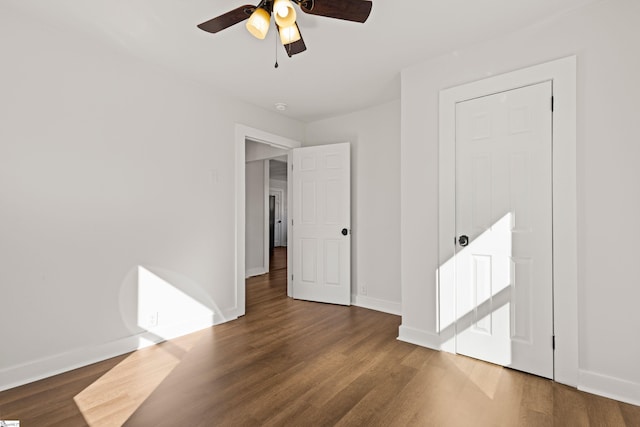 unfurnished bedroom with a ceiling fan, baseboards, and wood finished floors