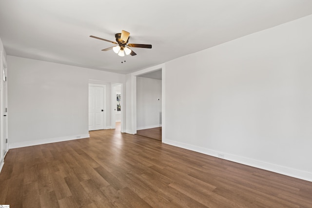 spare room with ceiling fan, baseboards, and wood finished floors