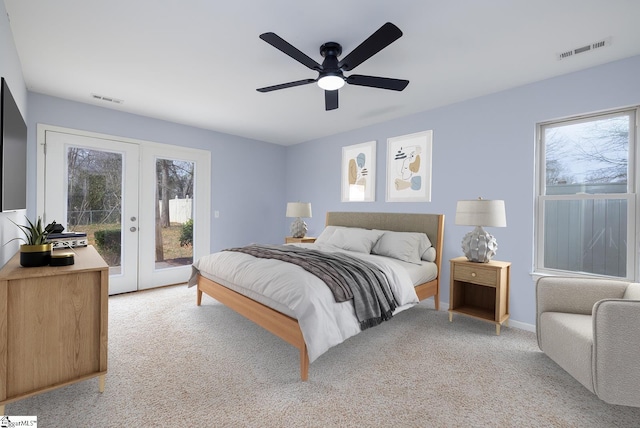 bedroom with multiple windows, visible vents, and access to exterior