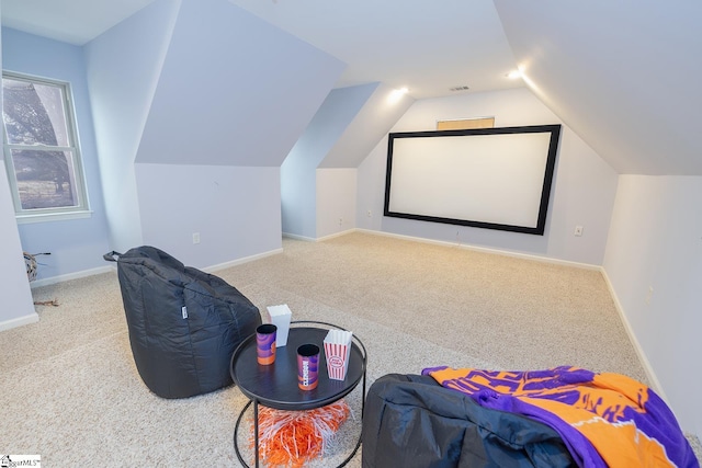 home theater with carpet, visible vents, baseboards, and vaulted ceiling