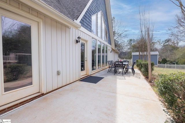 view of patio featuring outdoor dining area and fence