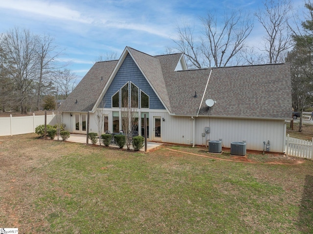 rear view of property with a yard, a fenced backyard, a patio area, and french doors