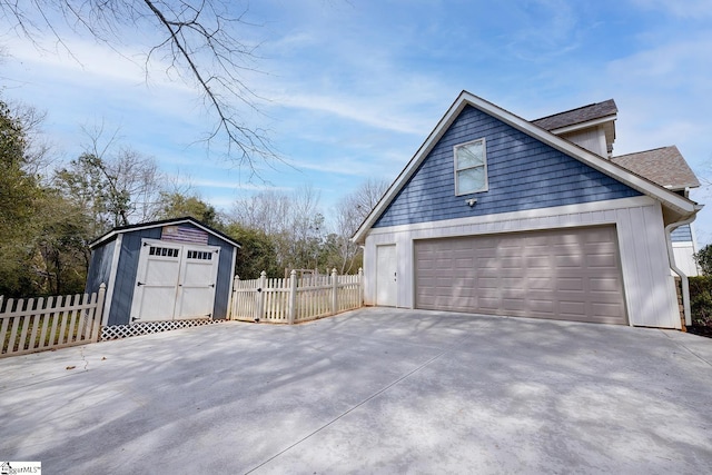 view of property exterior with fence, a shed, a garage, driveway, and an outdoor structure