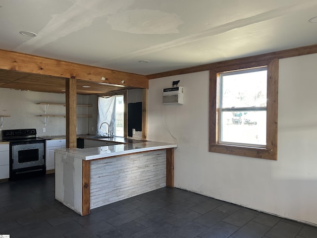 kitchen with white cabinets, a wall mounted air conditioner, a peninsula, stainless steel range with electric stovetop, and open shelves