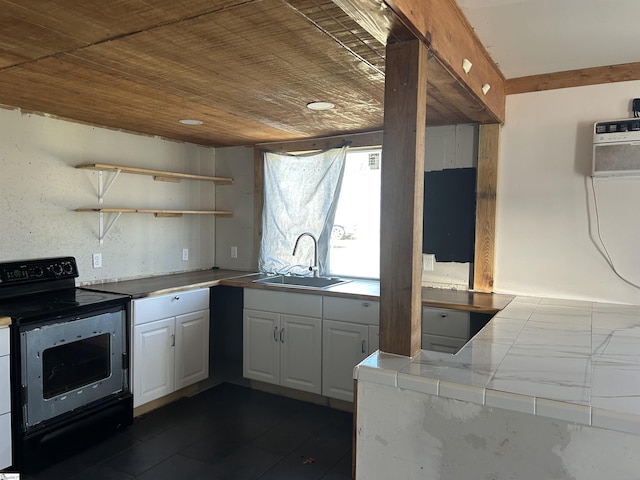 kitchen featuring tile countertops, electric range, a sink, white cabinets, and open shelves