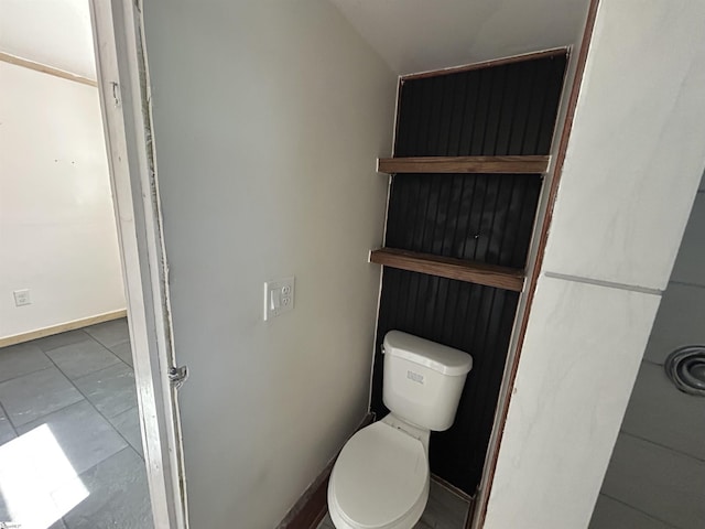 bathroom featuring toilet and baseboards