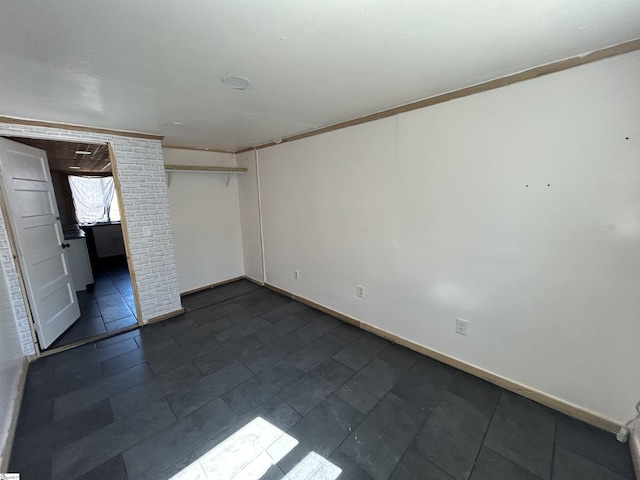 unfurnished bedroom featuring a closet and baseboards