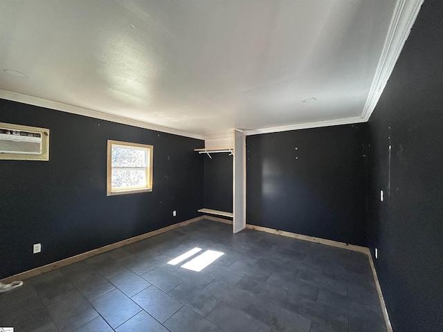 spare room with ornamental molding, a wall unit AC, and baseboards