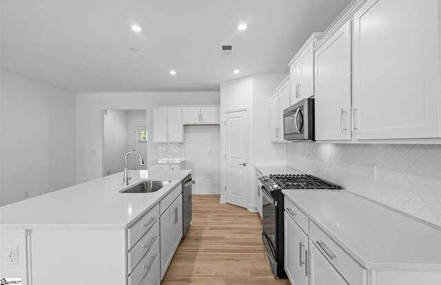 120 Indigo Cir Lot 35, Easley, SC 29642 - kitchen with a sink, appliances with stainless steel finishes, recessed lighting, light wood-style flooring, and tasteful backsplash