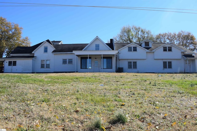 view of front of home featuring a front yard and a chimney