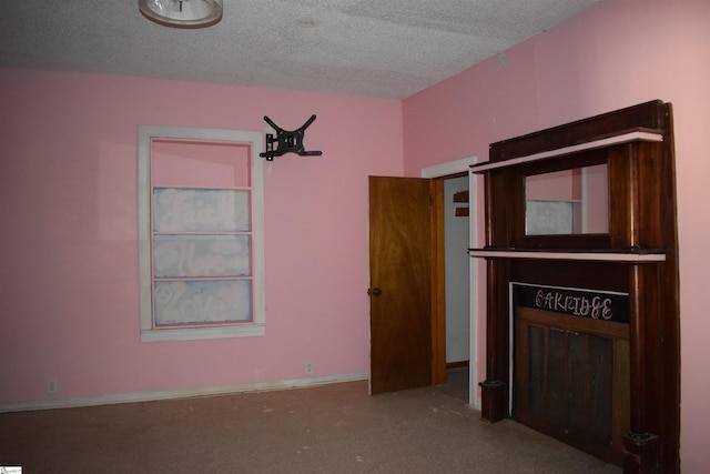 unfurnished bedroom featuring baseboards and a textured ceiling