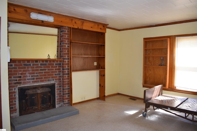 unfurnished living room with carpet, a brick fireplace, a wealth of natural light, and crown molding