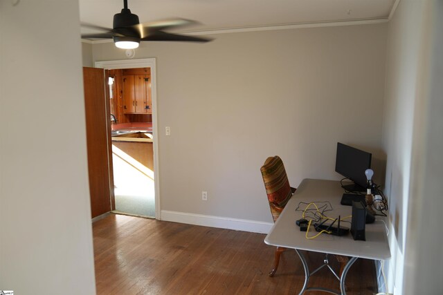 office space featuring ornamental molding, wood finished floors, a ceiling fan, and baseboards