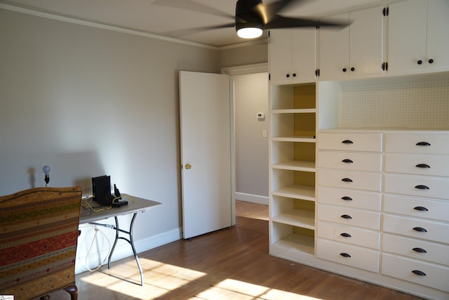 office space with a ceiling fan, crown molding, baseboards, and wood finished floors