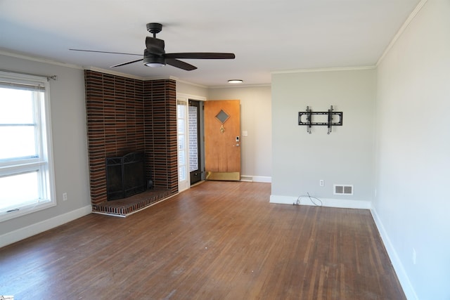 unfurnished living room featuring ornamental molding, a fireplace, and wood finished floors