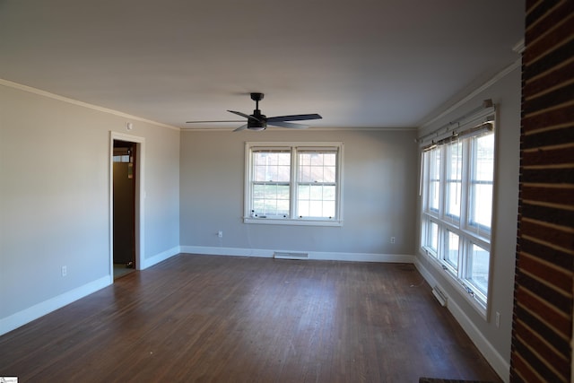 empty room featuring visible vents, ornamental molding, dark wood-type flooring, ceiling fan, and baseboards