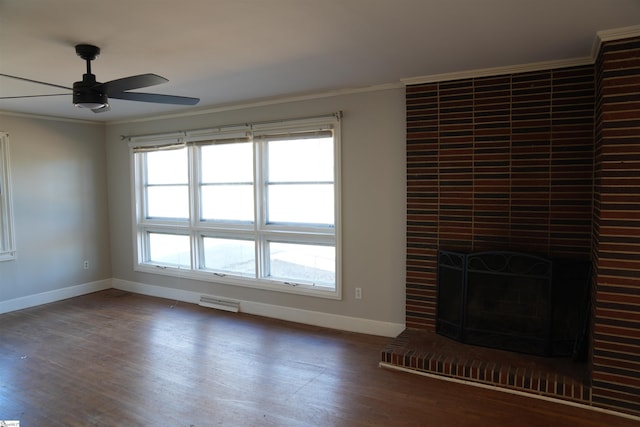 unfurnished living room featuring baseboards, ornamental molding, and wood finished floors