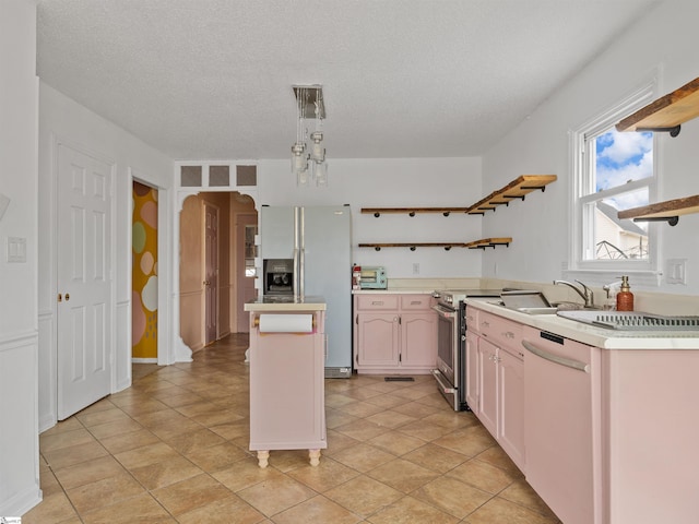 kitchen featuring arched walkways, stainless steel appliances, light countertops, a center island, and open shelves