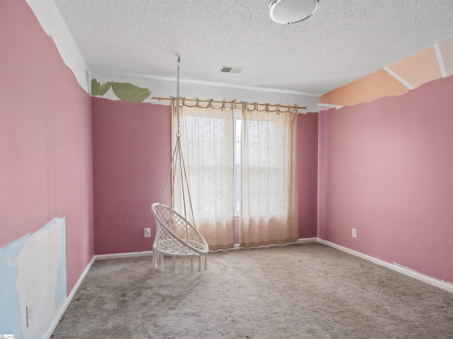 empty room with carpet flooring, visible vents, and baseboards