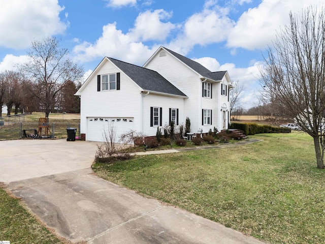 view of front of home featuring a garage, a front yard, driveway, and fence