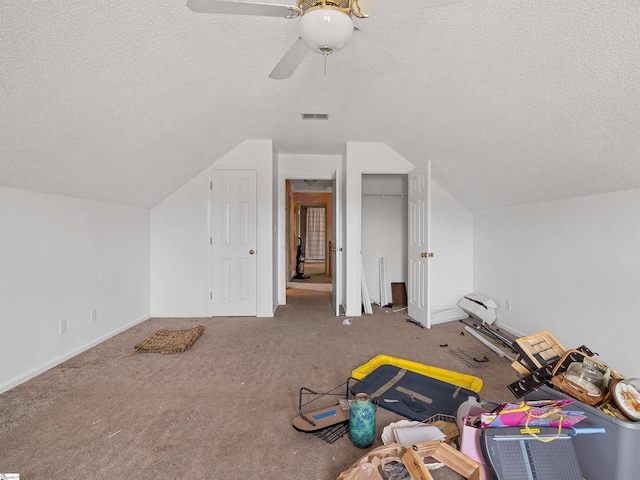 bonus room featuring visible vents, vaulted ceiling, a textured ceiling, and carpet flooring