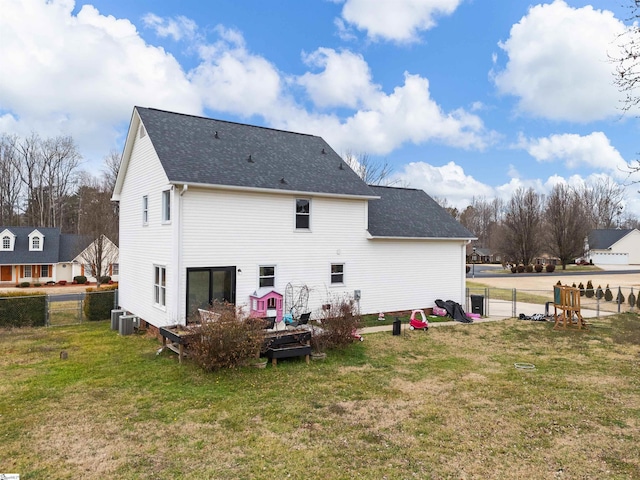 rear view of house featuring a deck, cooling unit, fence, a yard, and roof with shingles