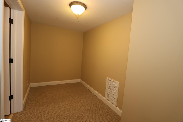 interior space with light carpet, visible vents, and baseboards