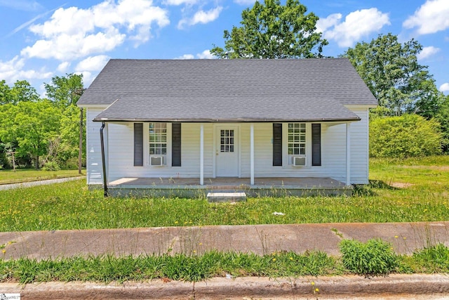 view of front of house featuring covered porch and a shingled roof