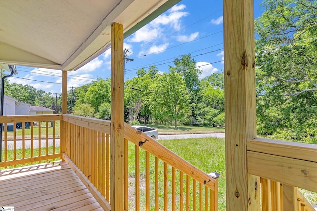 wooden terrace with a yard