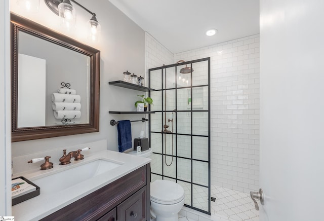 bathroom with a stall shower, vanity, and toilet