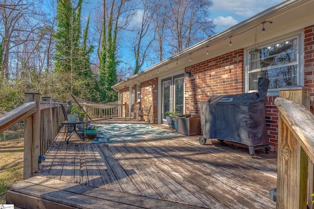 wooden terrace featuring grilling area