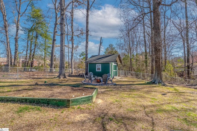 view of yard featuring a fire pit, an outdoor structure, and a fenced backyard