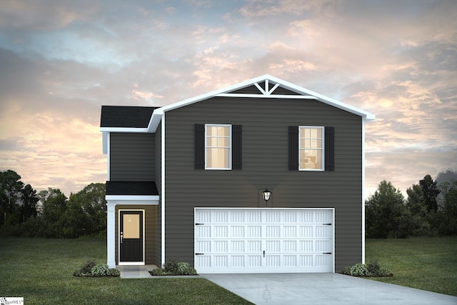 view of front facade featuring a garage, concrete driveway, and a yard