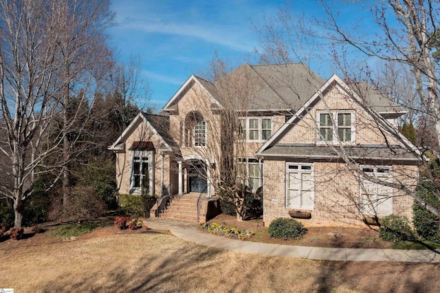 view of front of property with brick siding and a front yard