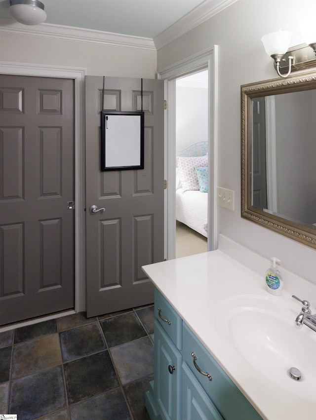 bathroom with ornamental molding and vanity