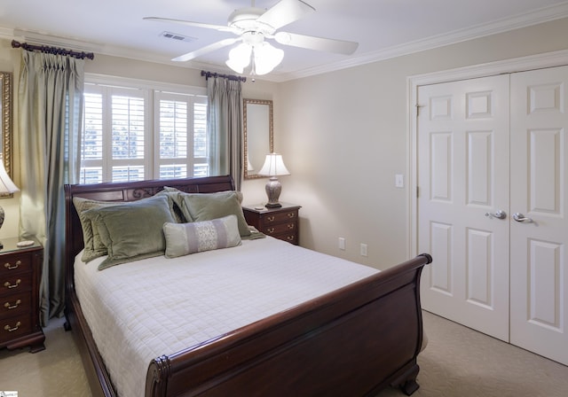 bedroom featuring light colored carpet, a ceiling fan, visible vents, ornamental molding, and a closet