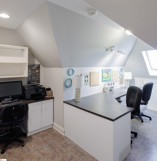 office space featuring lofted ceiling with skylight