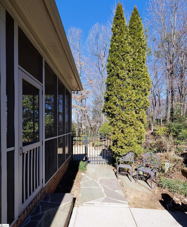 view of patio featuring a sunroom