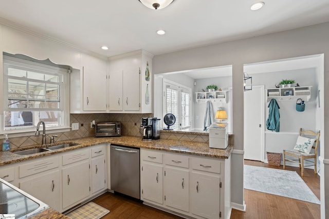 kitchen featuring a toaster, dark wood finished floors, white cabinets, a sink, and dishwasher