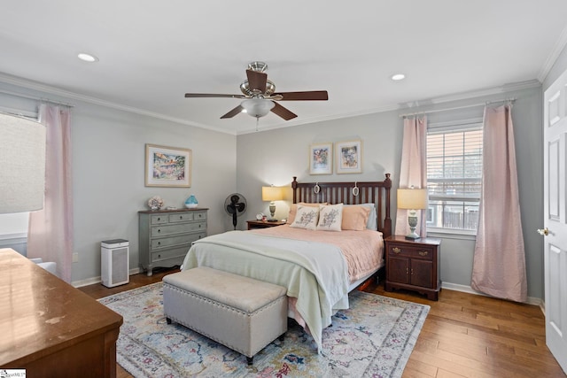 bedroom with crown molding, recessed lighting, ceiling fan, wood finished floors, and baseboards