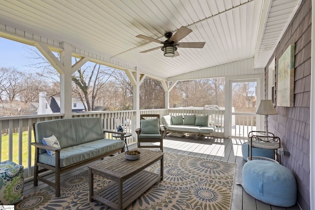 sunroom / solarium featuring wooden ceiling, vaulted ceiling, and a ceiling fan