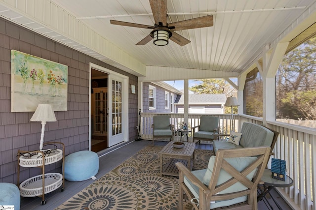 wooden terrace featuring an outdoor living space and a ceiling fan