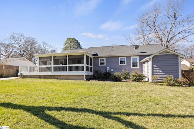 back of house featuring a sunroom, fence, and a yard