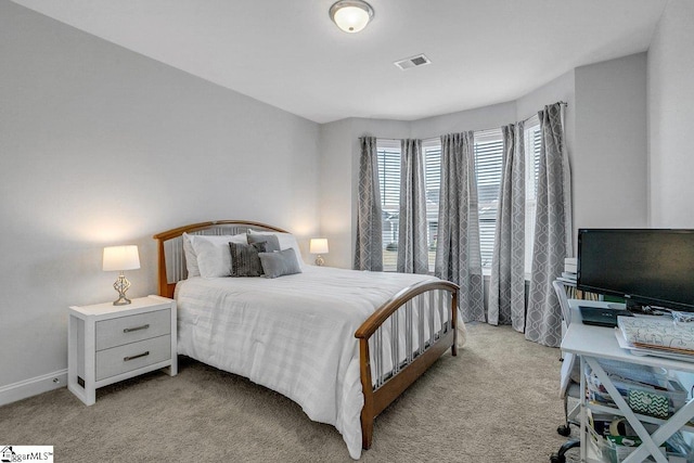 bedroom with light colored carpet, visible vents, and baseboards