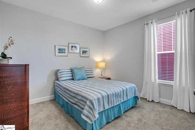 carpeted bedroom featuring baseboards